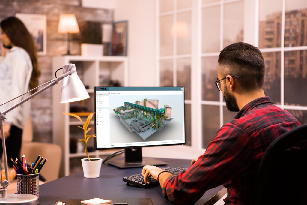 Back view of male engineer drawing a mechanical prototype