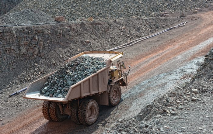 dumper truck with loaded stones driving along in a quarry. minin