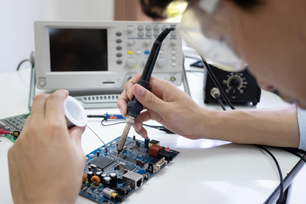 Technician checks the electronic device.