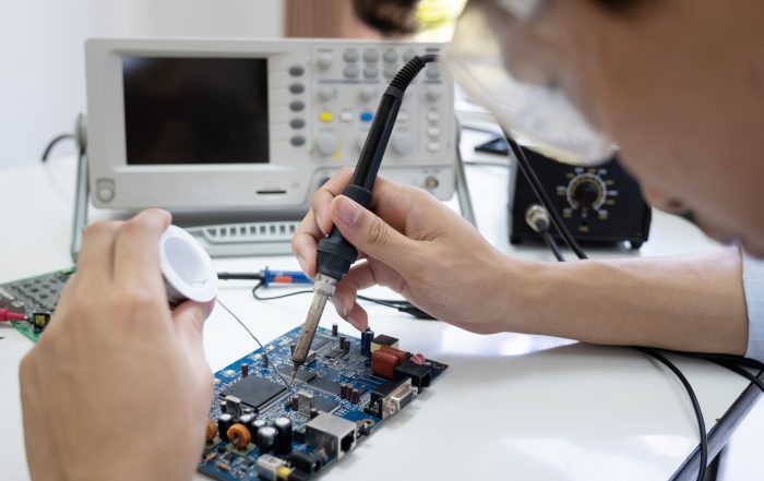 Technician checks the electronic device.