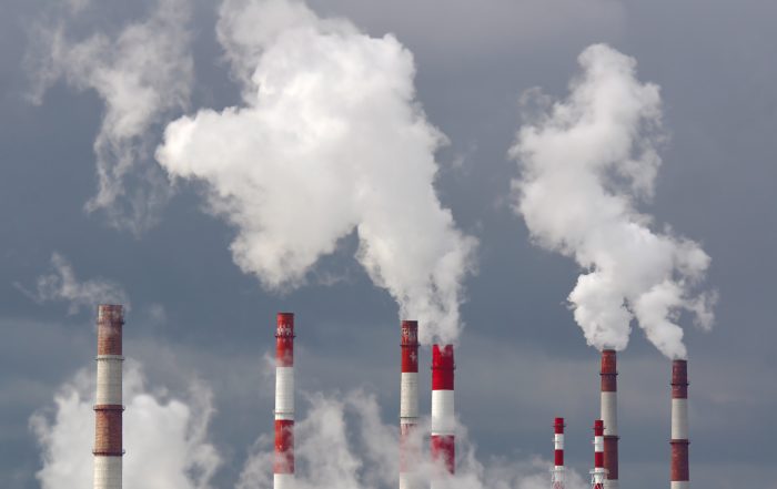 Smoking chimneys against the sky