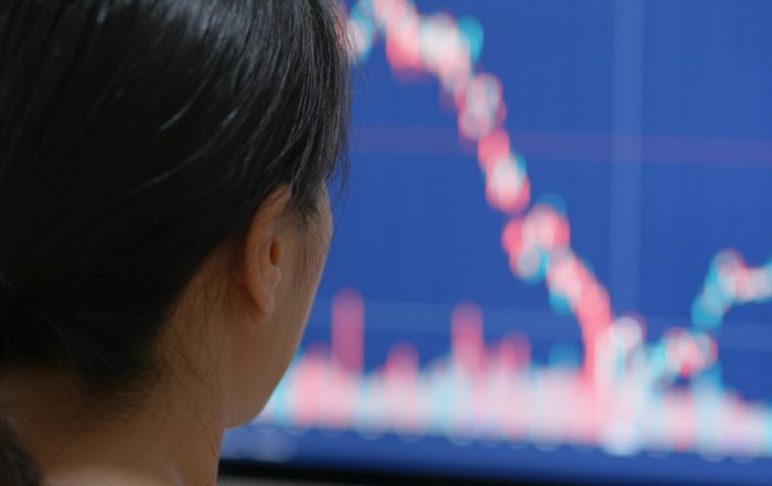 Woman watch on stock market data on computer