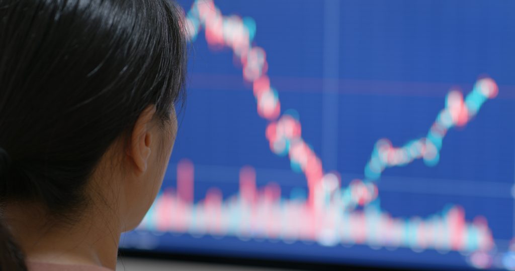 Woman watch on stock market data on computer