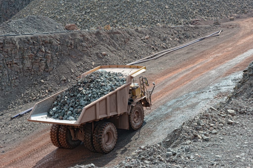 dumper truck with loaded stones driving along in a quarry. mining industry.