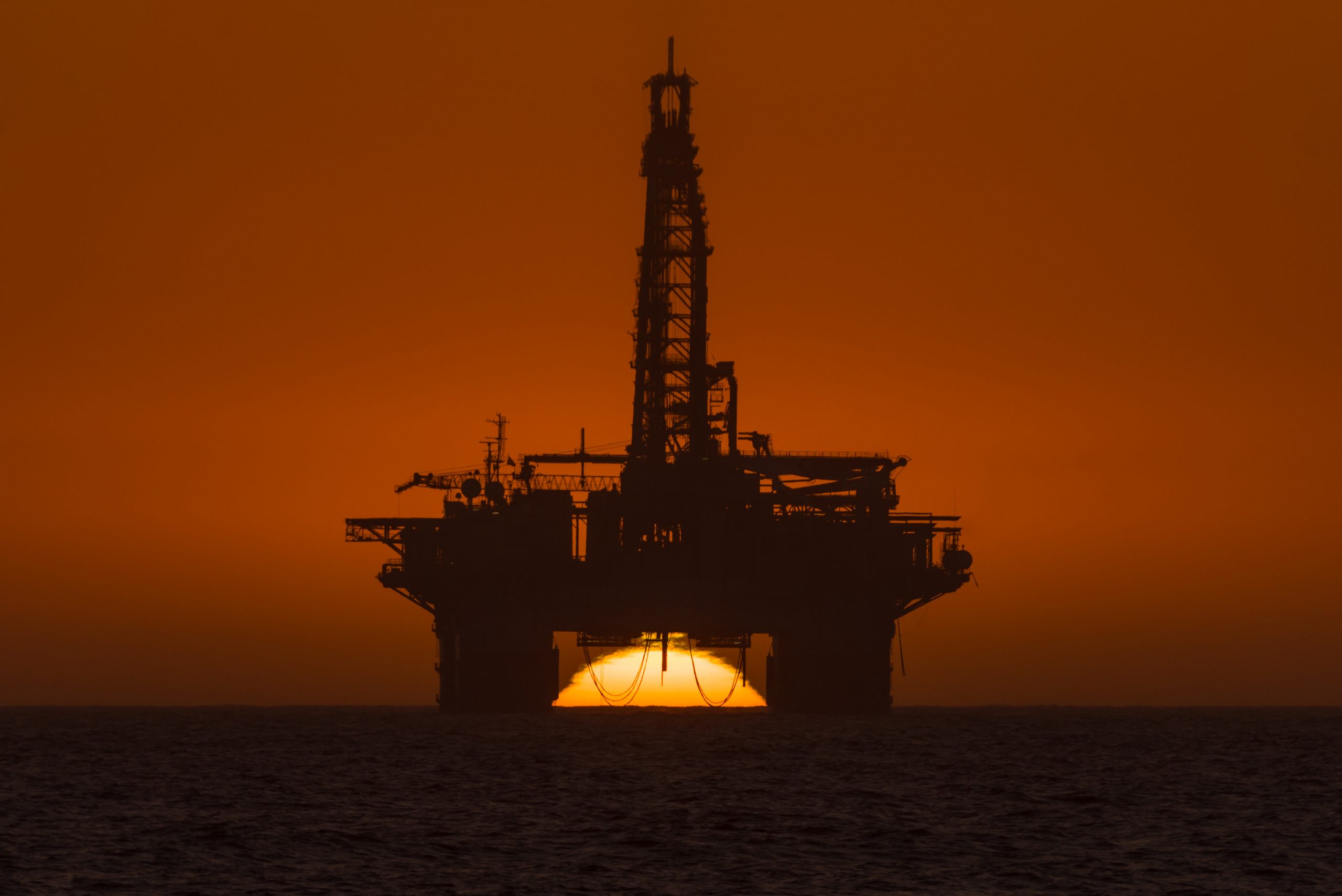 sun-setting-behind-oil-drilling-platform-at-longbe