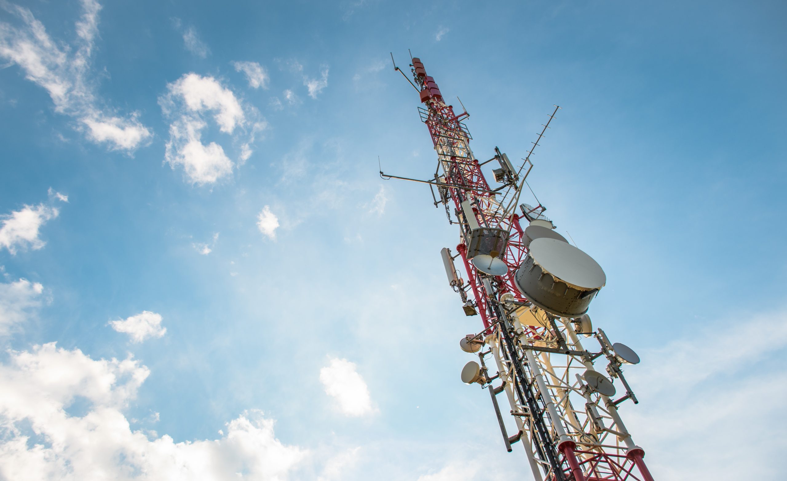 low-angle-view-of-antenna-tower-against-a-blue-sky-