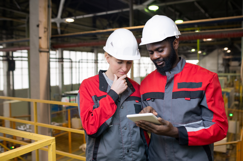 Leadership analyzing industrial production data from digital transformation