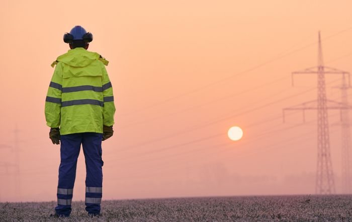 electrical-engineer-against-electricity-pylons