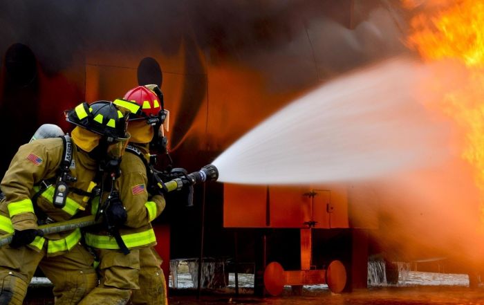 firemen controlling an explosion in an industry