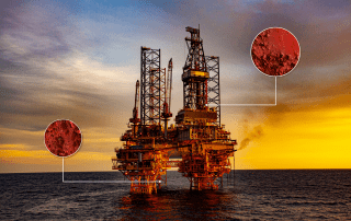 The importance of corrosion monitoring in Industries featured image. Offshore oil rig with corrosion poin in its structure