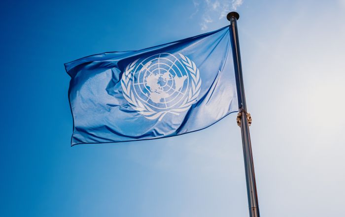 un flag against the sun and blue sky