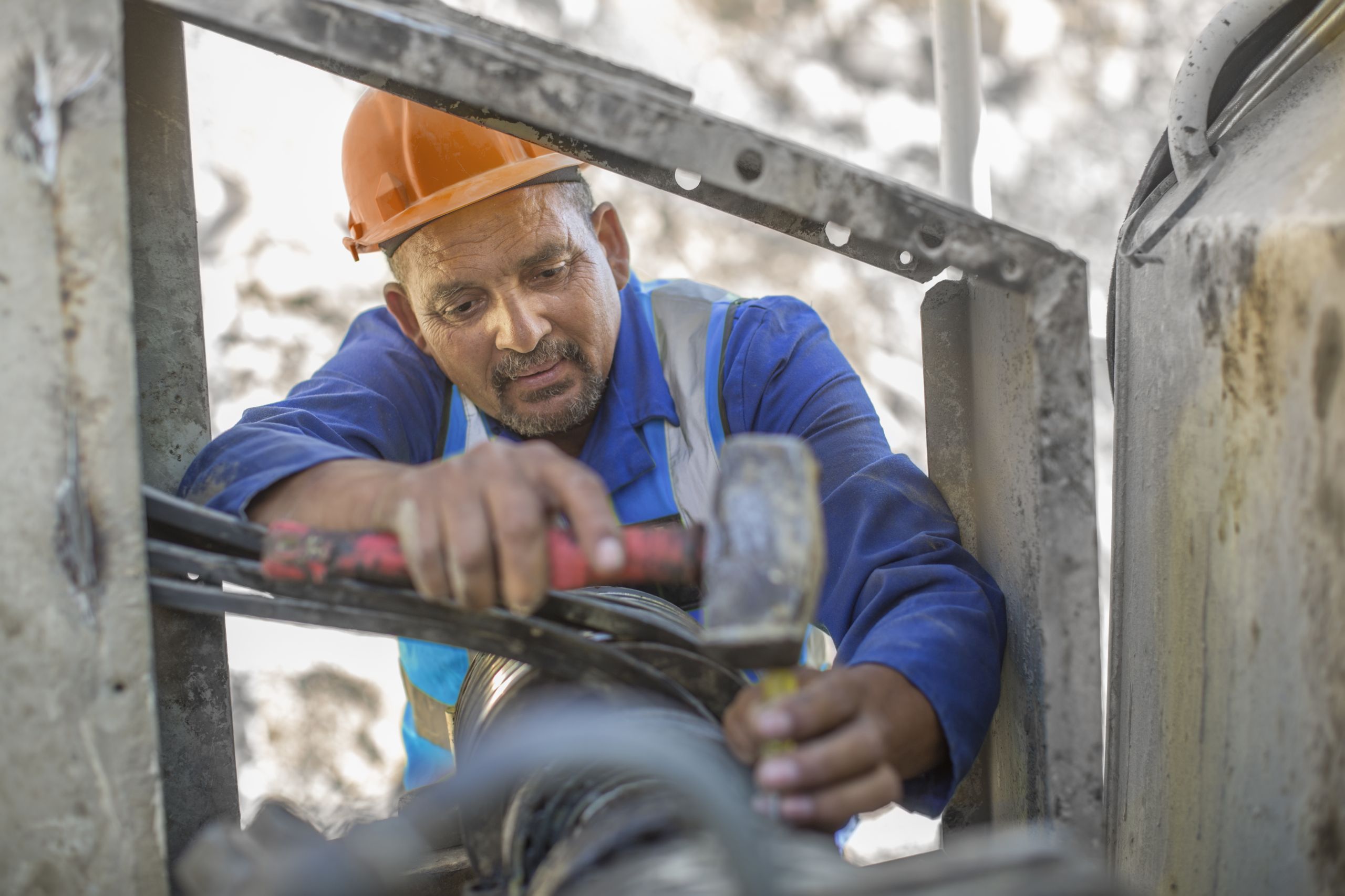 worker performing field repair maintenance