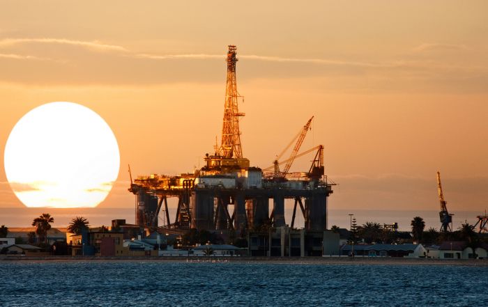 oil drilling platform at sunset