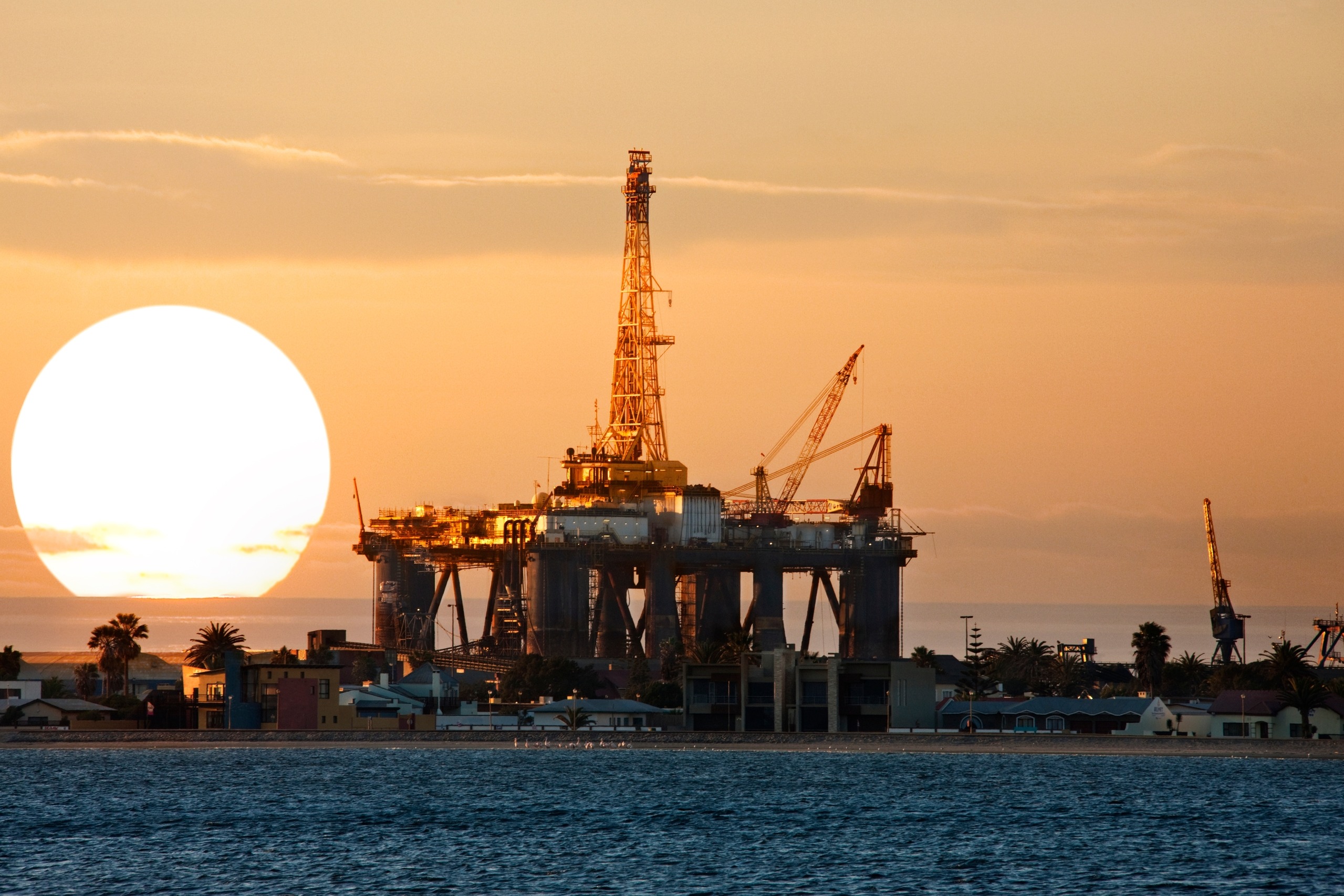 oil drilling platform at sunset