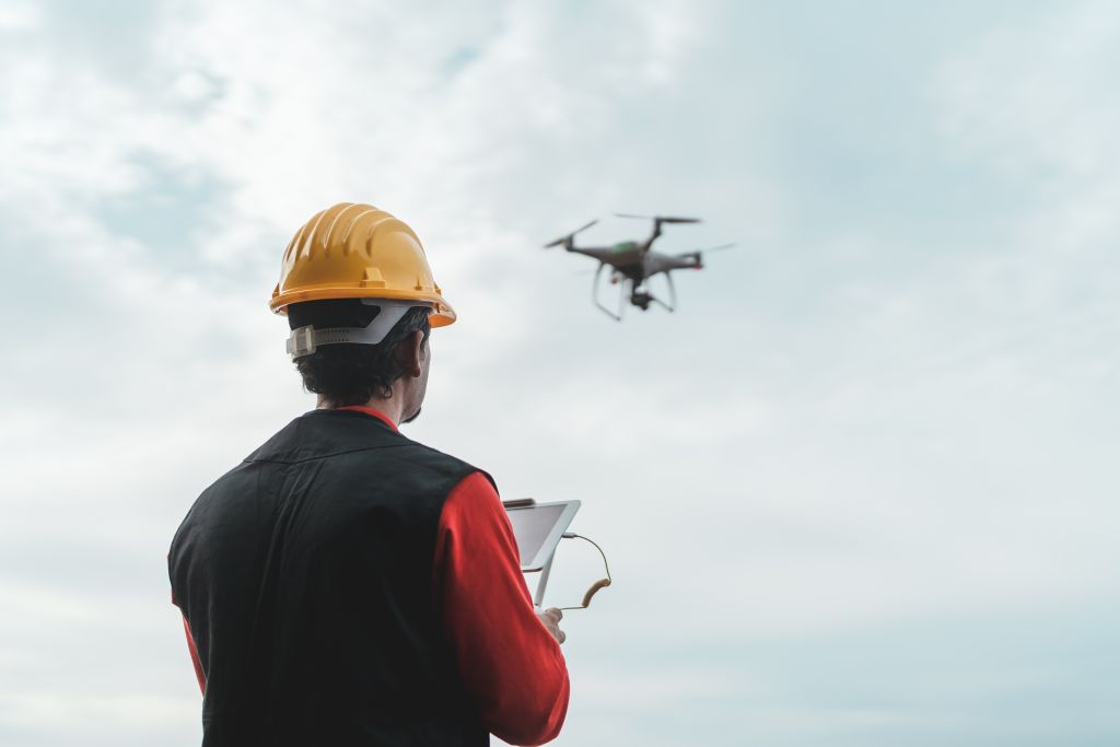 male engineer monitoring through drone images in oil and gas industry