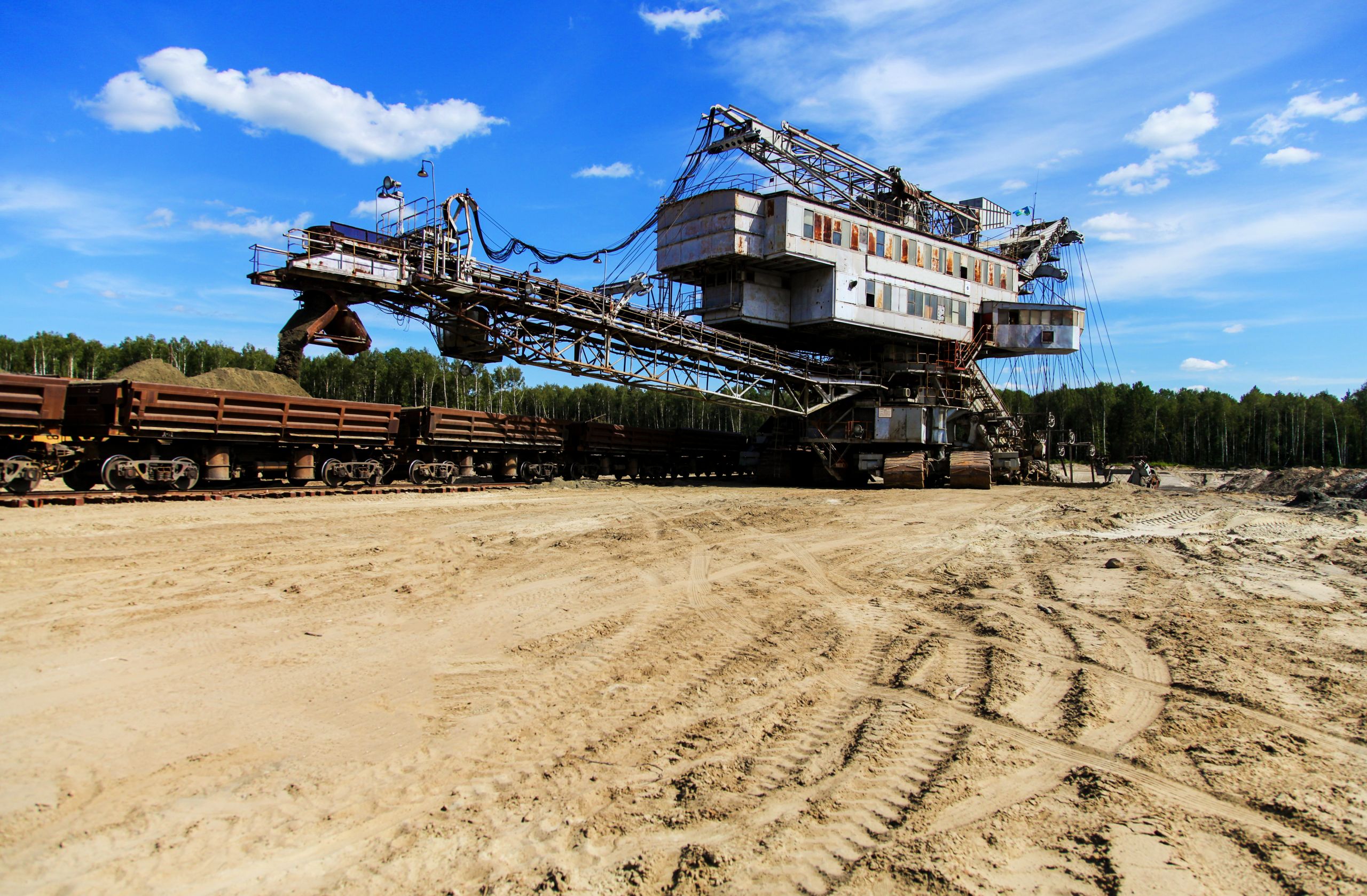 Mining machine loadind sand in train cars