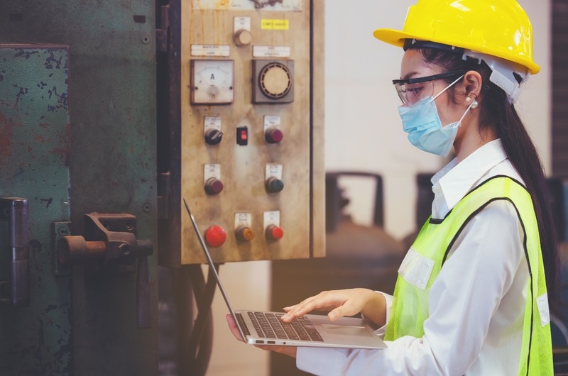 Industrial factory maintenance engineers woman inspect relay protection system of machinery and holding notebook with copy space. Industry, Maintenance, Engineering and construction
