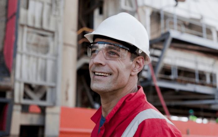 smiling engineer with FPSO behind