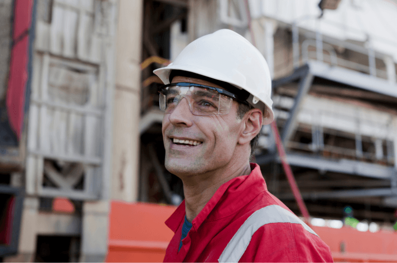 smiling engineer with FPSO behind