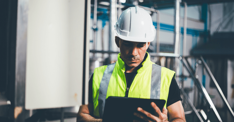 Reflexive engineer looking at integroty data at a tablet in an offshore procution facility