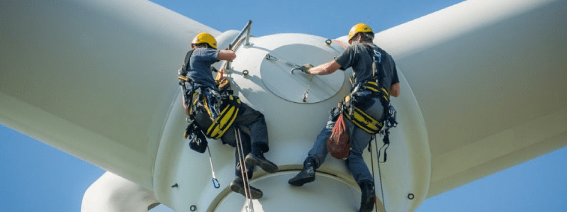 Photo of industrial climbers on wind turbine