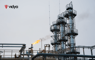 Industrial processing facility with flare stack and distillation columns, illustrating digital twin applications for asset integrity, inspection, and operational monitoring.