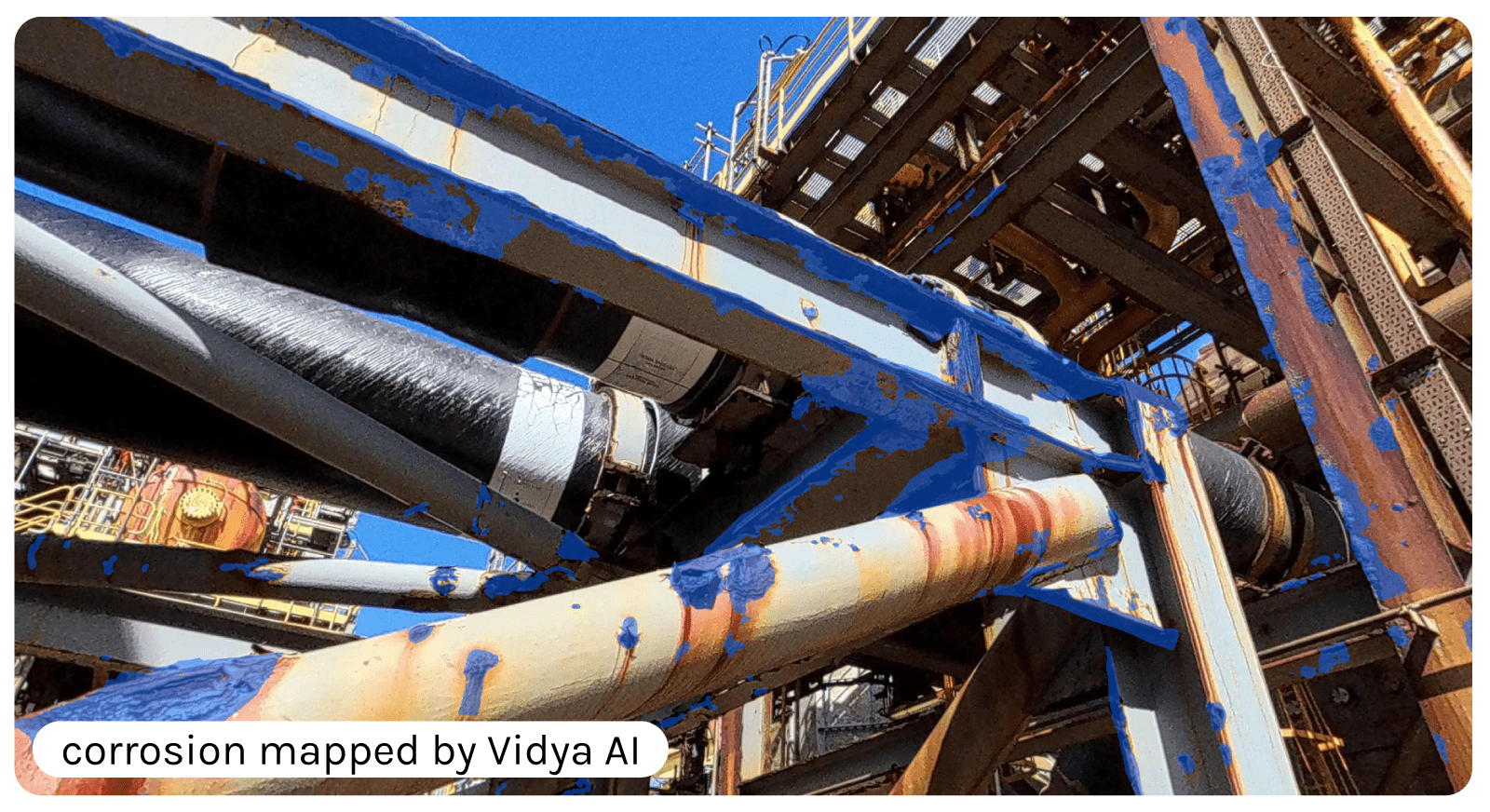 Industrial structure with pipes and metal beams, with corrosion areas highlighted in blue by artificial intelligence.